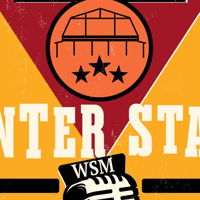 A camera films Steve Earle on stage at the Grand Ole Opry